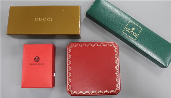 One Cartier box, two Gucci boxes and a Dragon House box.